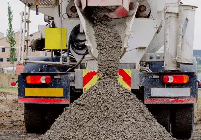 The rear chute of a ready-mix mixer discharging fresh concrete — ready-mix concrete insurance in Florida
